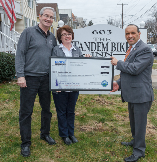 Michael and Anne Marie Hayes of Tandem Bike Inn      Freeholder Thomas A. Arnone (to the right of sign)